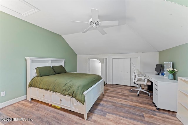 bedroom featuring ceiling fan, baseboards, wood finished floors, and vaulted ceiling