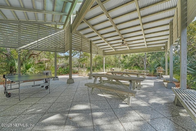 surrounding community with outdoor dining area and a patio area