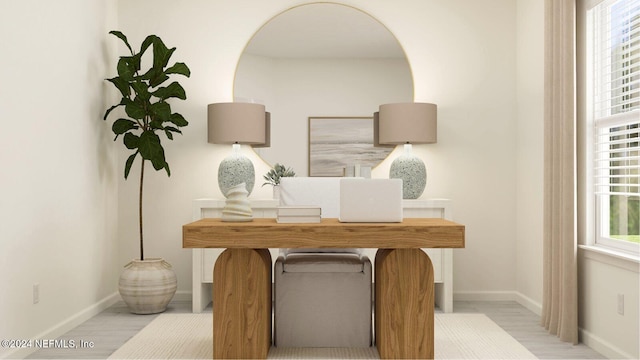 office featuring light wood-style flooring and baseboards