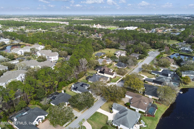 drone / aerial view with a water view and a residential view