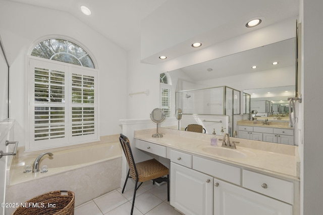 bathroom featuring lofted ceiling, a garden tub, tile patterned flooring, vanity, and a shower stall