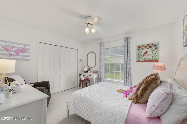 bedroom featuring ceiling fan, a closet, and light colored carpet