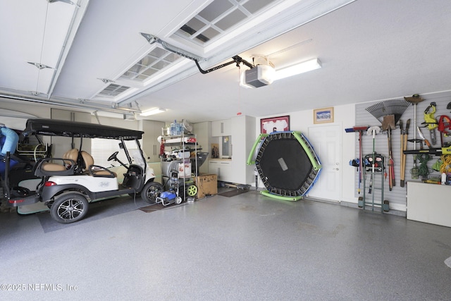 garage with a garage door opener and electric panel