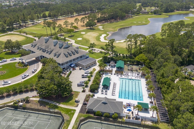 drone / aerial view featuring view of golf course and a water view