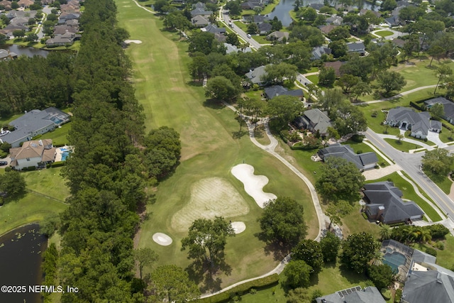 aerial view with a residential view, a water view, and golf course view