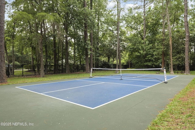 view of tennis court featuring fence