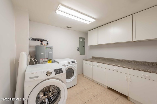 laundry area featuring cabinet space, electric water heater, light tile patterned flooring, electric panel, and independent washer and dryer