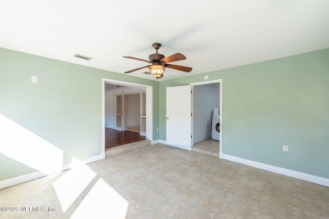 empty room with baseboards, visible vents, and ceiling fan