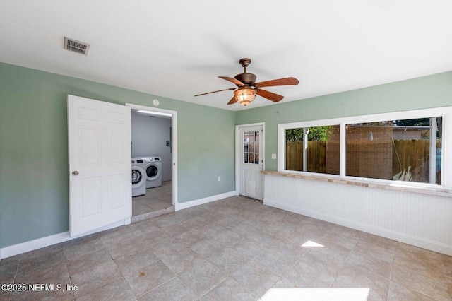 interior space featuring separate washer and dryer, a ceiling fan, visible vents, and baseboards