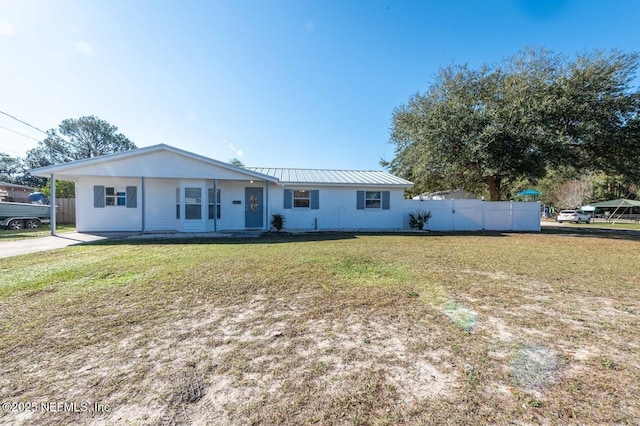 ranch-style house with metal roof, a front lawn, and fence