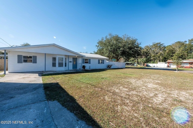 single story home featuring metal roof, driveway, and a front lawn