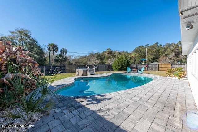 view of pool with a patio area, a fenced backyard, a fenced in pool, and a jacuzzi