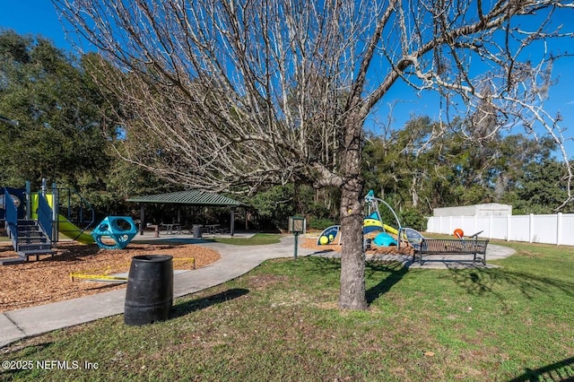 view of yard featuring fence, playground community, and a gazebo