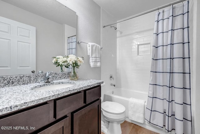 full bath with toilet, wood finished floors, vanity, and shower / bathtub combination with curtain