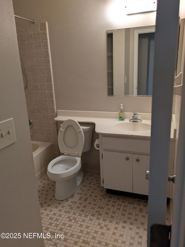 bathroom featuring toilet, bathing tub / shower combination, and vanity