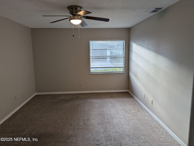 spare room with baseboards, visible vents, a textured ceiling, and carpet flooring