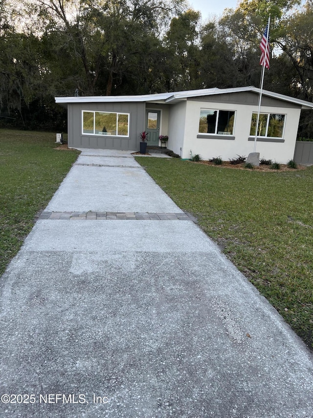 view of front of house featuring a front yard and board and batten siding