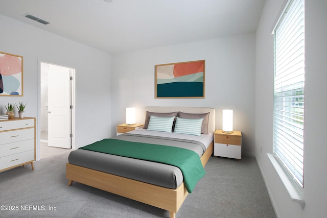 bedroom with visible vents and light carpet