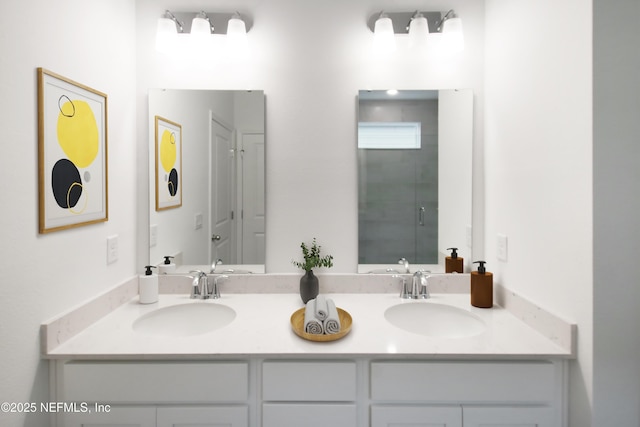 full bath with a stall shower, a sink, and double vanity