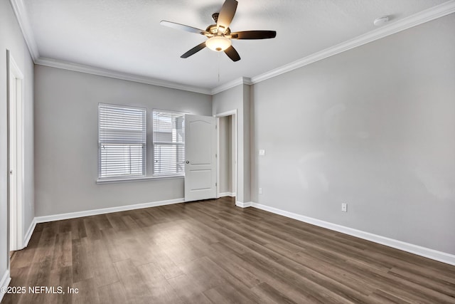 unfurnished room with dark wood-type flooring, ornamental molding, baseboards, and ceiling fan