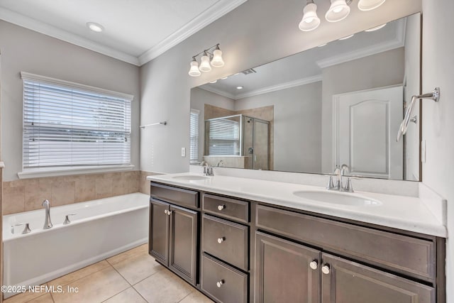 bathroom featuring double vanity, a shower stall, a sink, and tile patterned floors