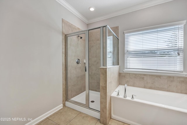 bathroom featuring crown molding, a stall shower, a garden tub, and tile patterned floors