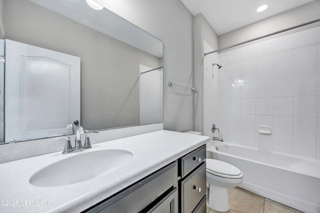 bathroom featuring toilet, bathing tub / shower combination, vanity, and tile patterned floors