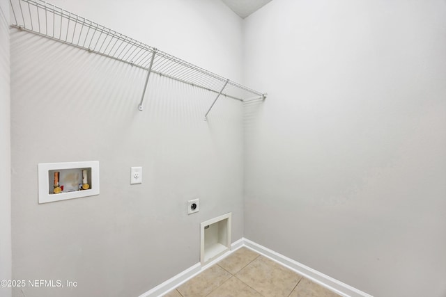 clothes washing area featuring light tile patterned floors, hookup for a washing machine, hookup for an electric dryer, laundry area, and baseboards