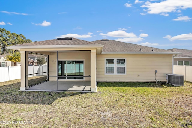 back of house with a yard, central AC, and fence