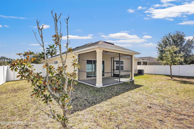 back of property with a lawn, cooling unit, and a fenced backyard