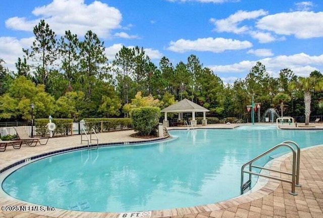 community pool featuring a patio area, fence, and a gazebo