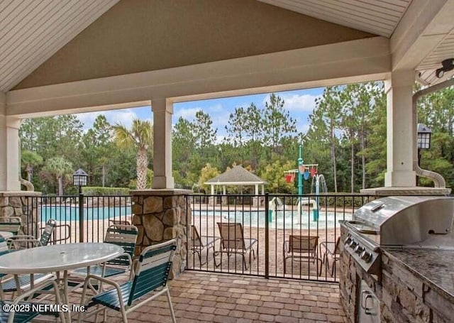 view of patio featuring a gazebo, area for grilling, fence, and a community pool