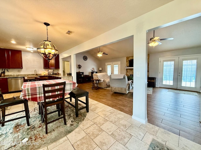 dining space featuring ceiling fan, visible vents, a textured ceiling, and french doors