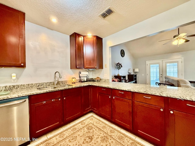 kitchen featuring reddish brown cabinets, visible vents, open floor plan, a sink, and dishwasher