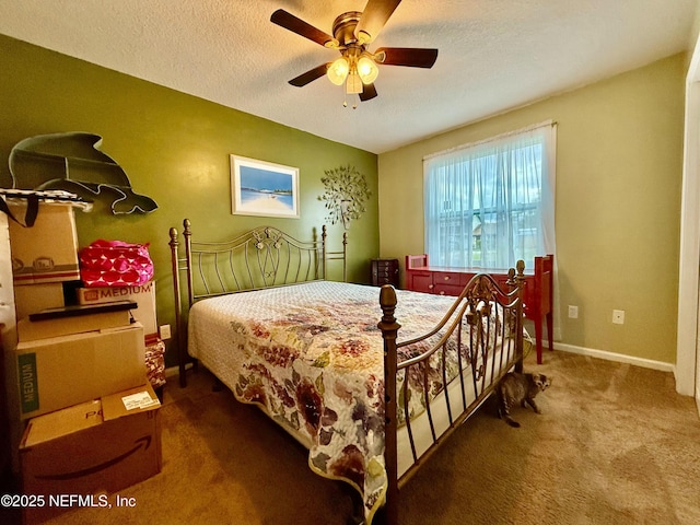 bedroom featuring ceiling fan, baseboards, a textured ceiling, and carpet flooring