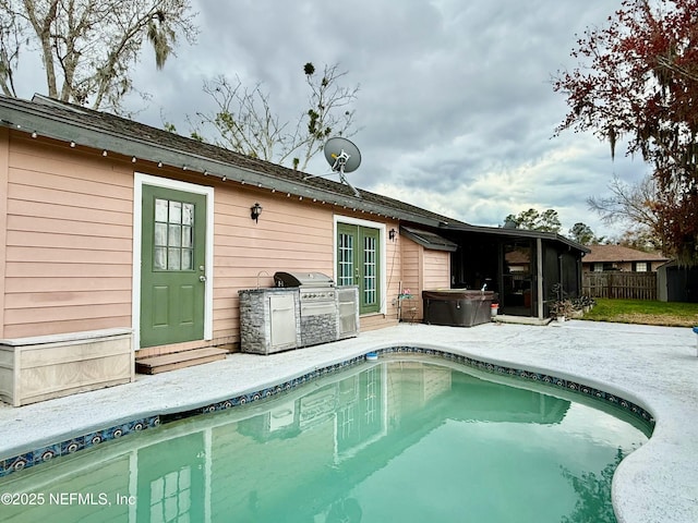 back of property featuring a patio area, fence, a fenced in pool, and a hot tub