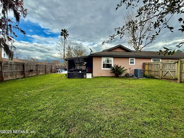 view of yard featuring a fenced backyard and central AC unit