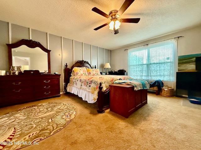 carpeted bedroom with a textured ceiling and ceiling fan