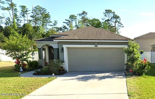 view of front of property with a front yard, driveway, an attached garage, and stucco siding