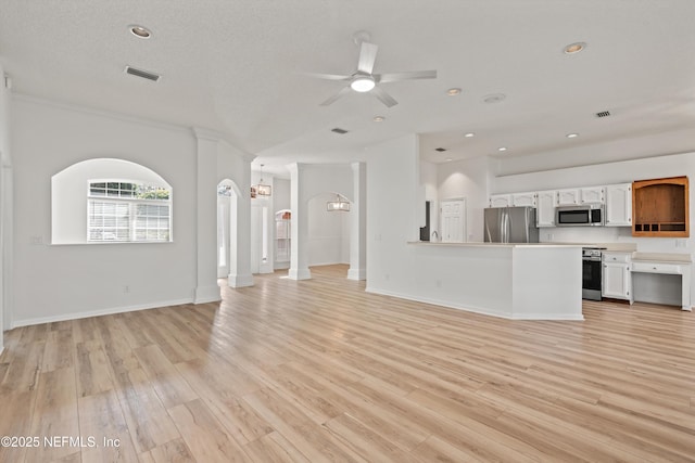 unfurnished living room featuring light wood-style floors, recessed lighting, visible vents, and ceiling fan with notable chandelier