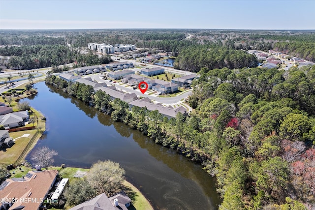 aerial view featuring a water view and a forest view