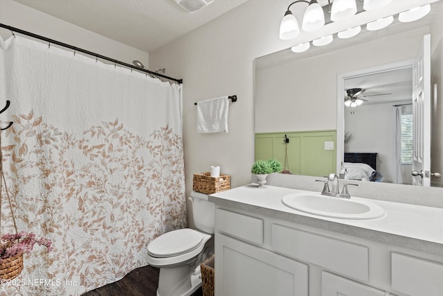 full bath featuring ensuite bathroom, a textured ceiling, toilet, visible vents, and vanity