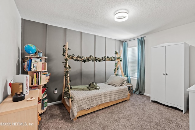 bedroom with carpet and a textured ceiling