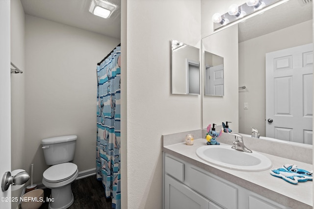 full bath featuring toilet, wood finished floors, vanity, baseboards, and a shower with curtain