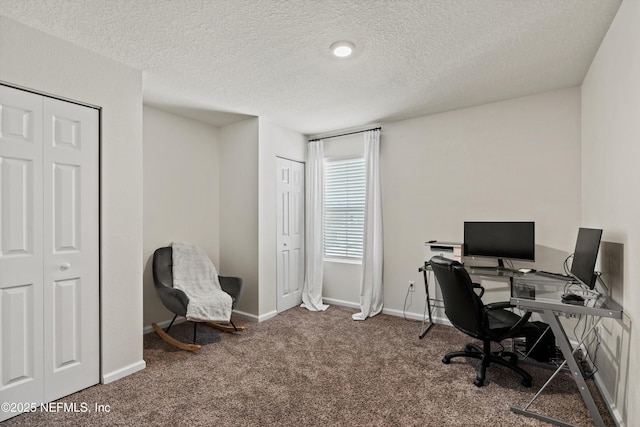 office area featuring a textured ceiling, carpet, and baseboards