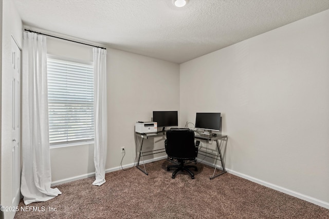 home office featuring a textured ceiling, carpet flooring, and baseboards