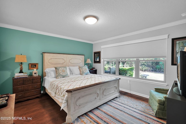 bedroom featuring ornamental molding, dark wood-style flooring, a textured ceiling, and baseboards