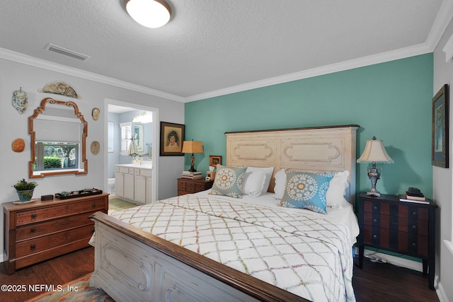 bedroom with a textured ceiling, connected bathroom, dark wood-type flooring, visible vents, and ornamental molding