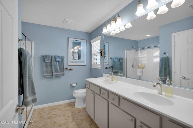 full bath featuring a shower stall, visible vents, a sink, and tile patterned floors