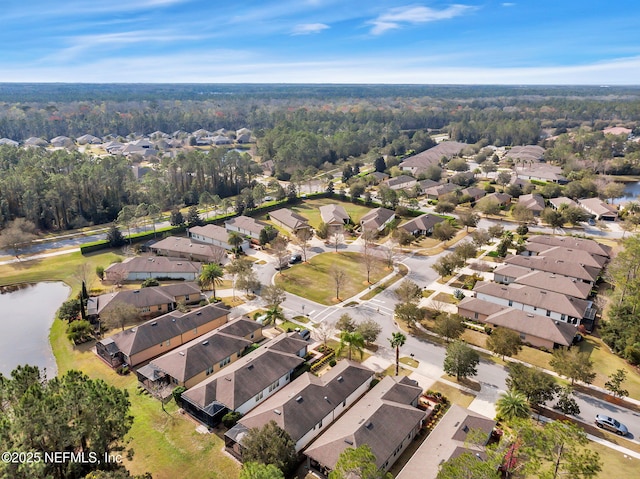 drone / aerial view featuring a residential view and a water view